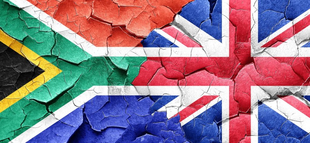 South africa flag with Great Britain flag on a grunge cracked wa